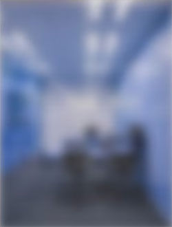 青い会議室で打ち合わせする人々