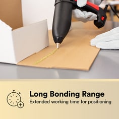 Adhesive is dispensed onto corrugated material for positioning. The asset states Long Bonding Range, extended working time for positioning.