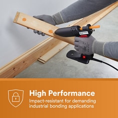 Hot melt adhesive is applied to a structural wood assembly. The asset states High Performance, impact-resistant for demanding industrial bonding applications.
