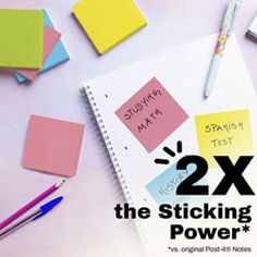 Post-it® Neon Fizz promotional image showing a blue lined sticky note on a light wood surface with an apple nearby. Text in image reads: “Love you Mom,” “2X the Sticking Power*,” and “*vs. original Post-it® Notes.”