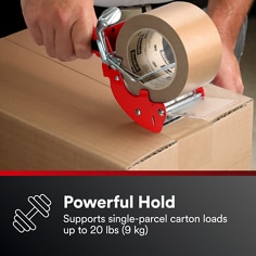 A red tape dispenser applies paper tape to a carton. The visible text is Powerful Hold, Supports single-parcel carton loads up to 20 lbs (9 kg).