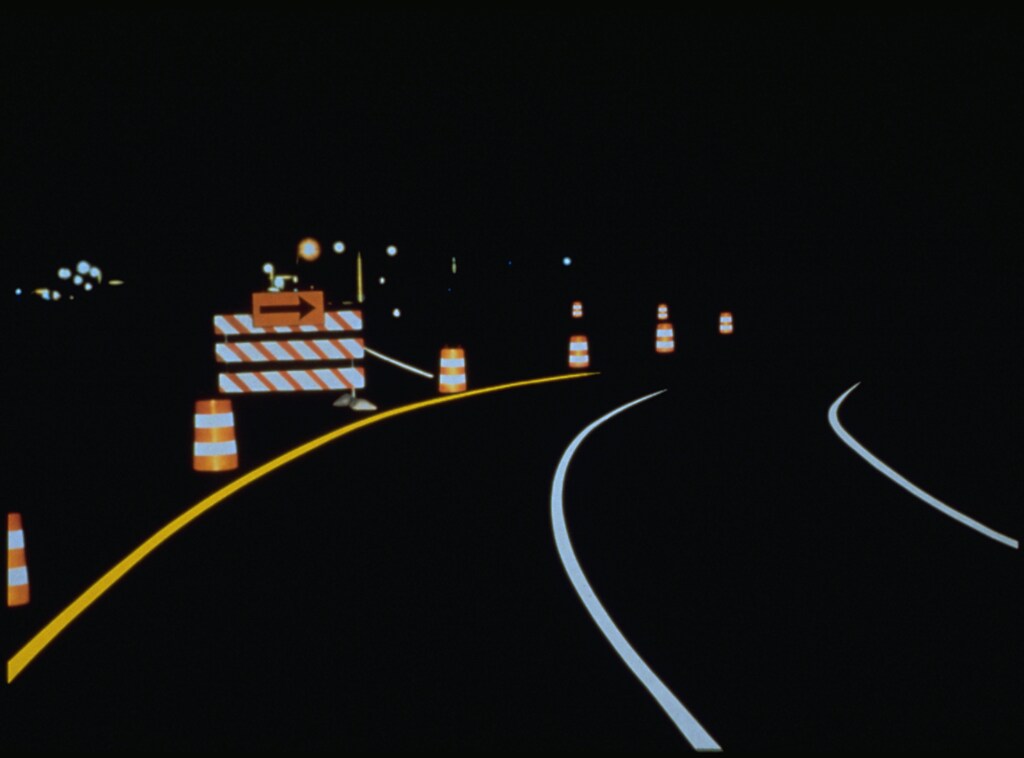 Reflective road lane markings shining from headlights during nightime driving