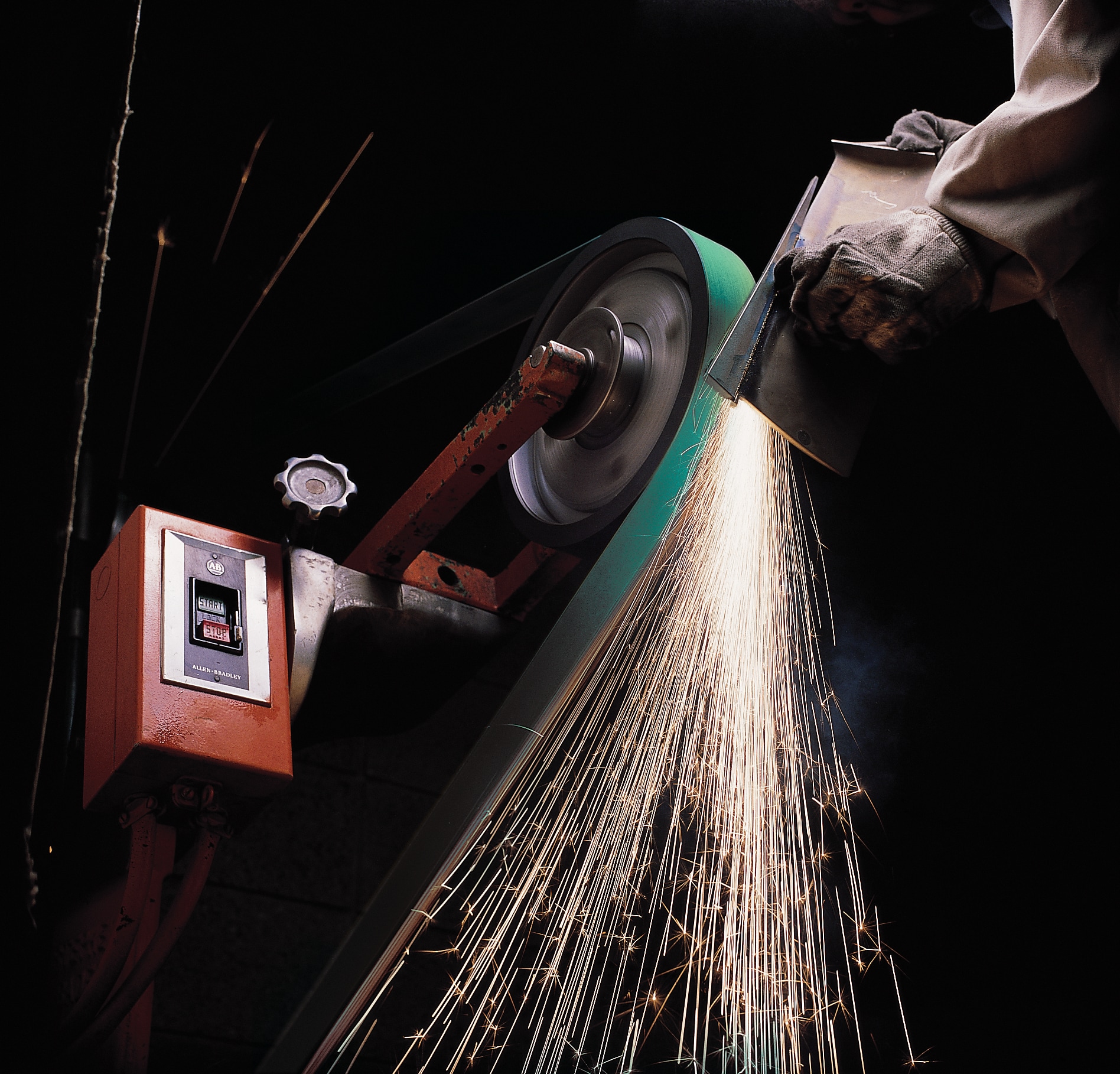 Metal grinding with sparks on an abrasive belt