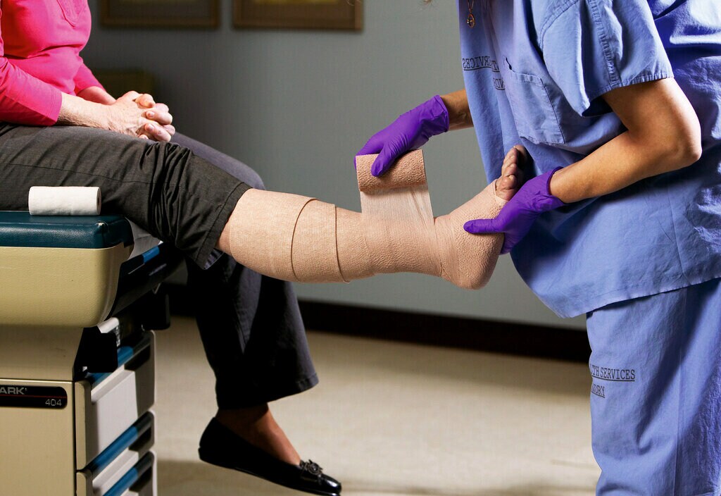 nurse wrapping patients leg