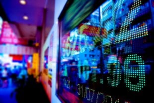 A vibrant digital display showing stock market data with numbers and graphs.