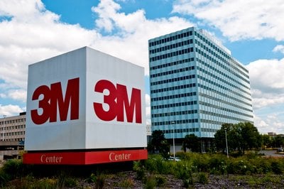Large 3M logo displayed on a white cube structure labeled Center in front of a multi-story office building.